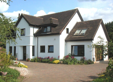 White rendered ICF house with brown tiled roof