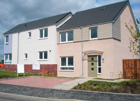 Pair of semi detached social houses clad in brick, timber and render