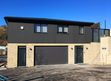 A Wallform ICF Live-Work building, with stone cladding at ground floor level and composite cladding at first
