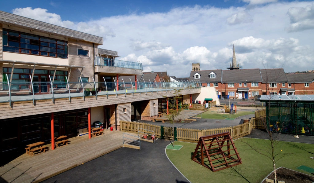 A large multi-storey school building clad with horizontal timber cladding