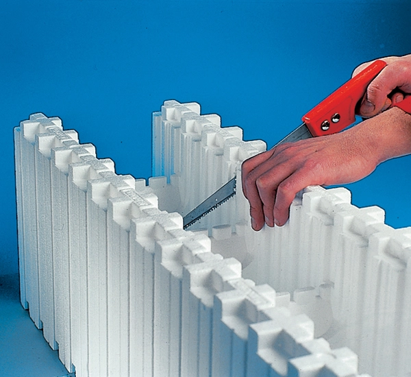 A builder using a pad saw to cut through a wallblock from the Wallform insulated concrete formwork system