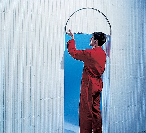 A builder removing an archway cutout from the Wallform insulated concrete formwork system to form an arched doorway