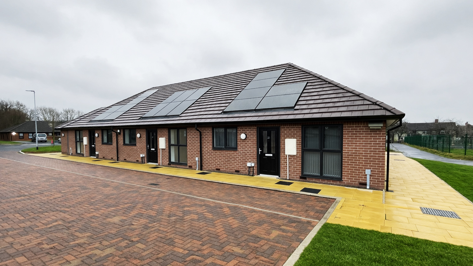 Another set of bungalows built with Wallform 313, clad in brick render and also showing the positioning of solar panels on the rooftops